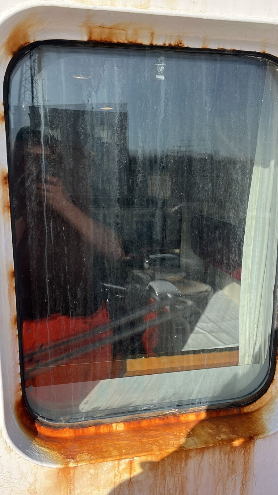 Window frame with heavy rust staining before restoration on M/S Romantika